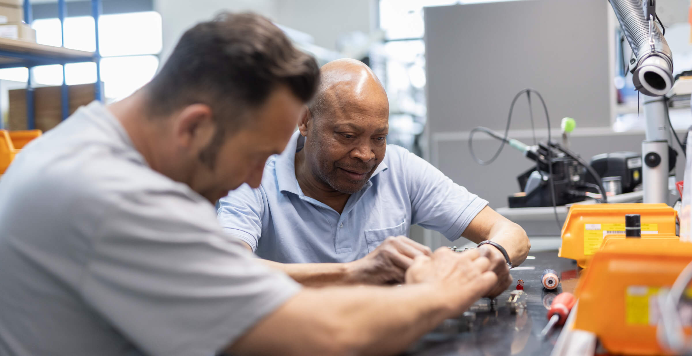 Employees assembling technical components