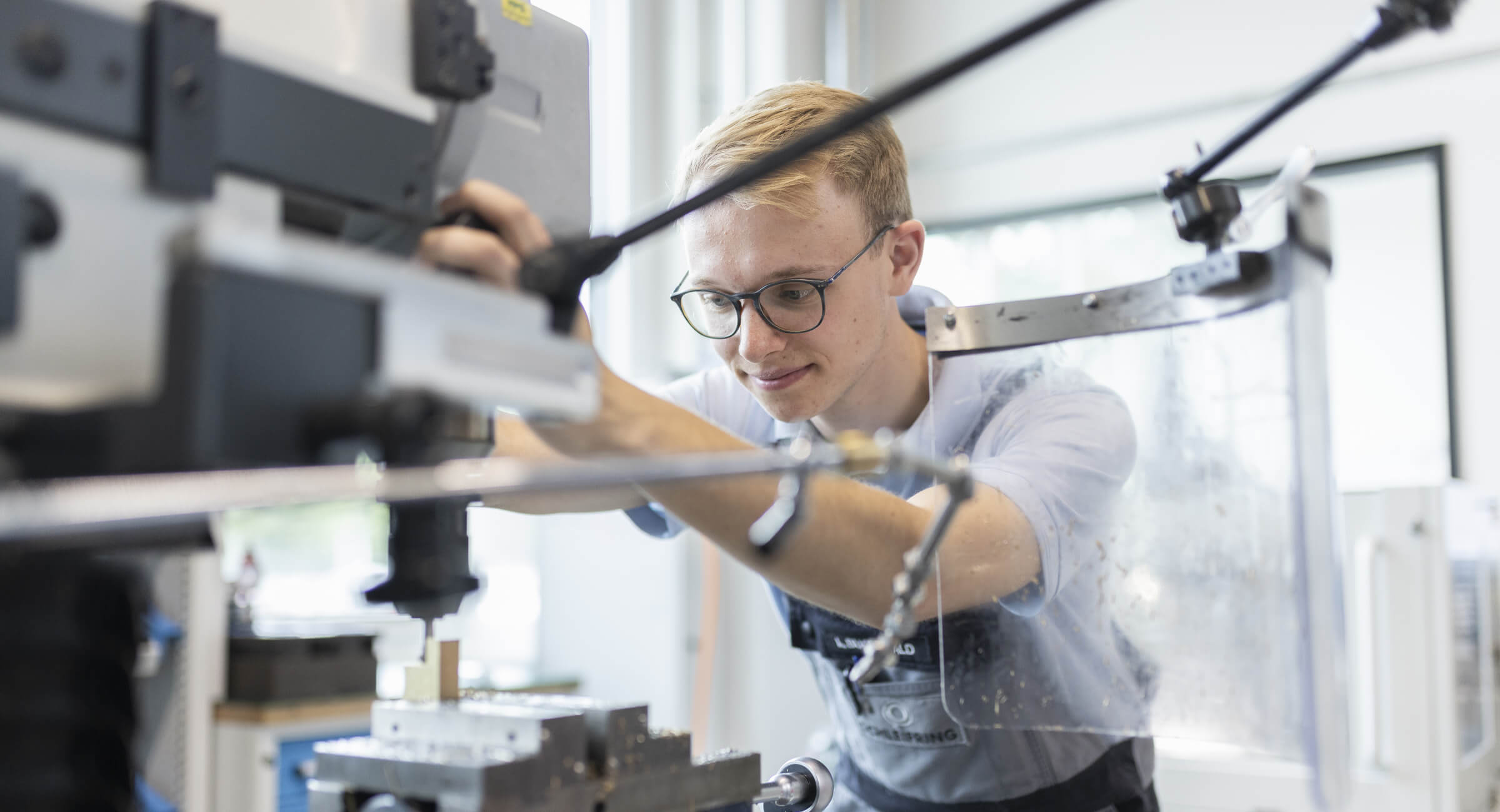 Employee at Schleifring operates a machine in production