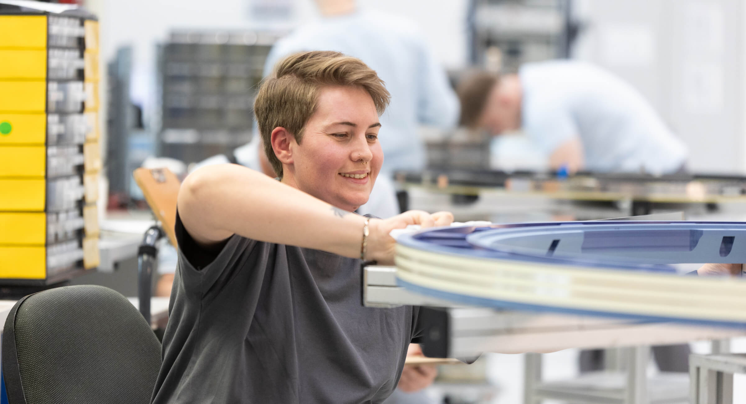Employee assembling a slip ring in production.