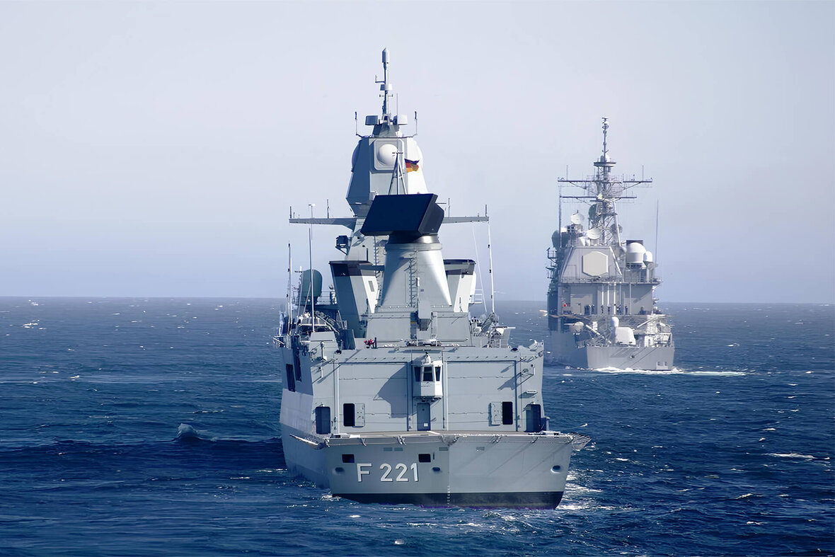 Two naval frigates on the high seas – in front frigate F221 in calm seas
