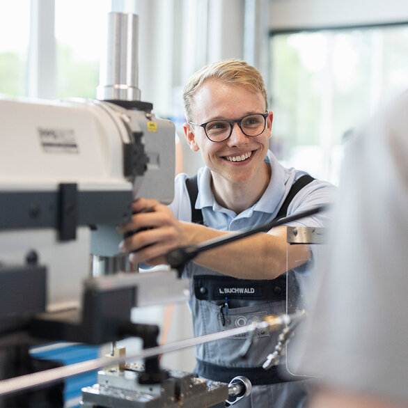 Apprentice at SCHLEIFRING working on a drill press