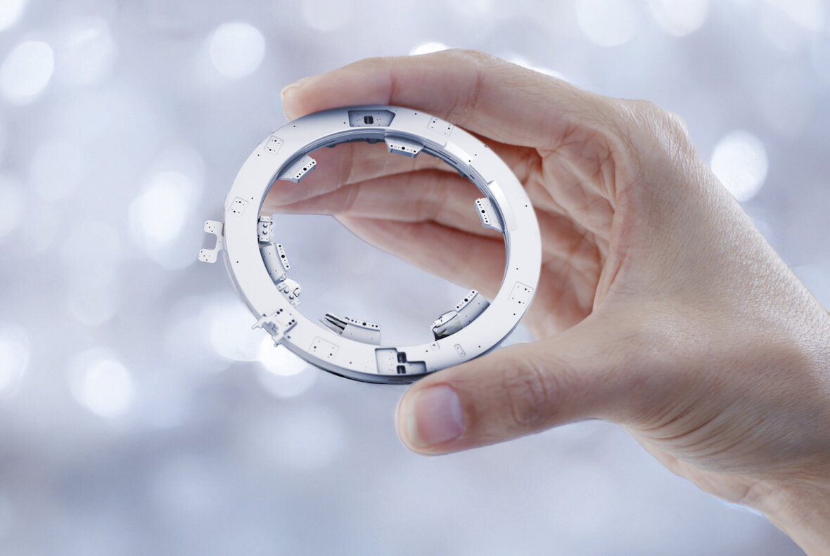 Hand holding a compact contactless slip ring for high-quality image data transmission.
