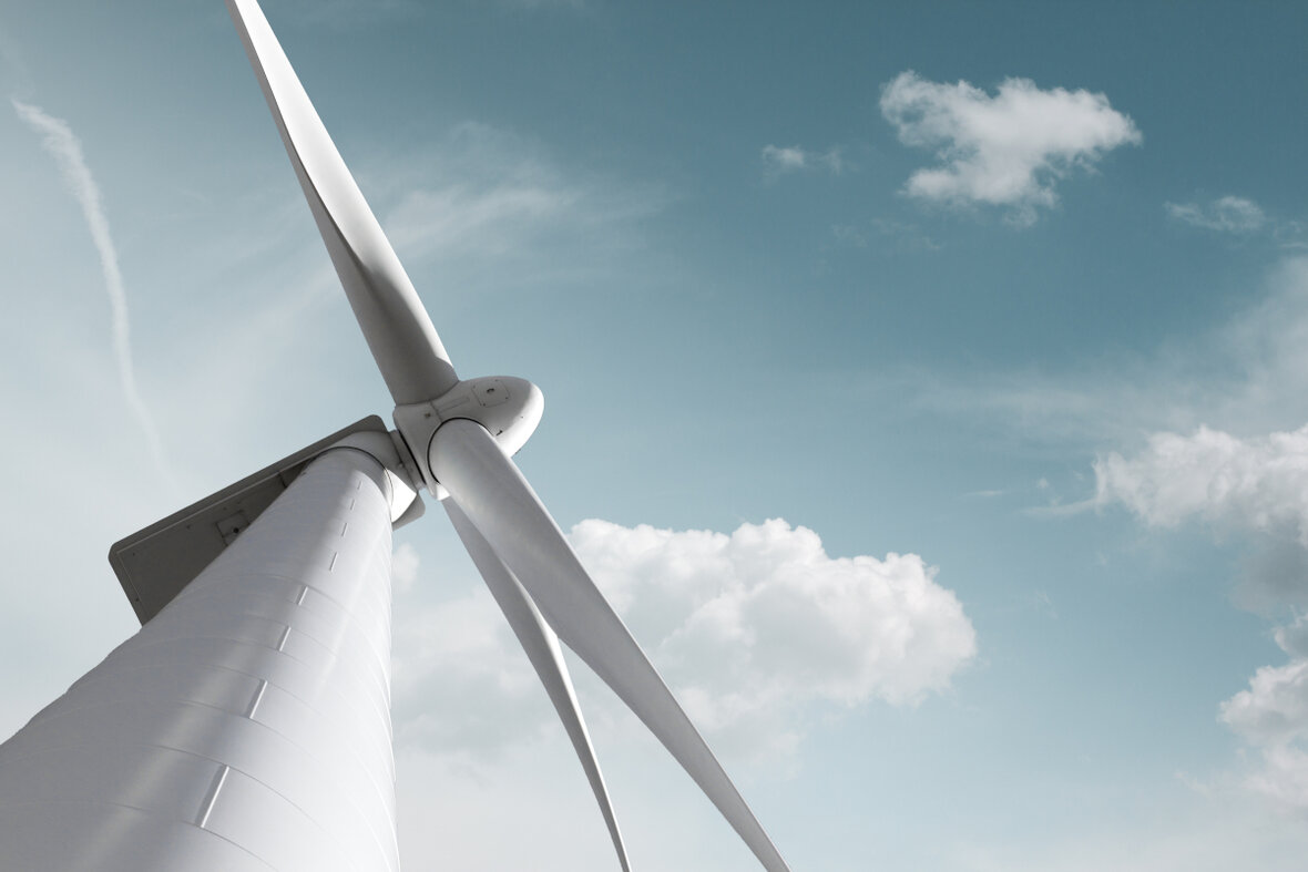 Close-up of a modern wind turbine with blue sky in the background