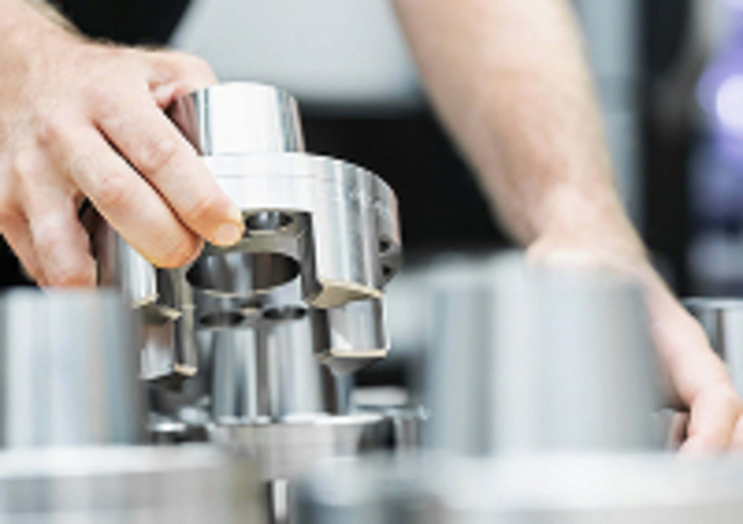 A SCHLEIFRING employee inspects a spare part