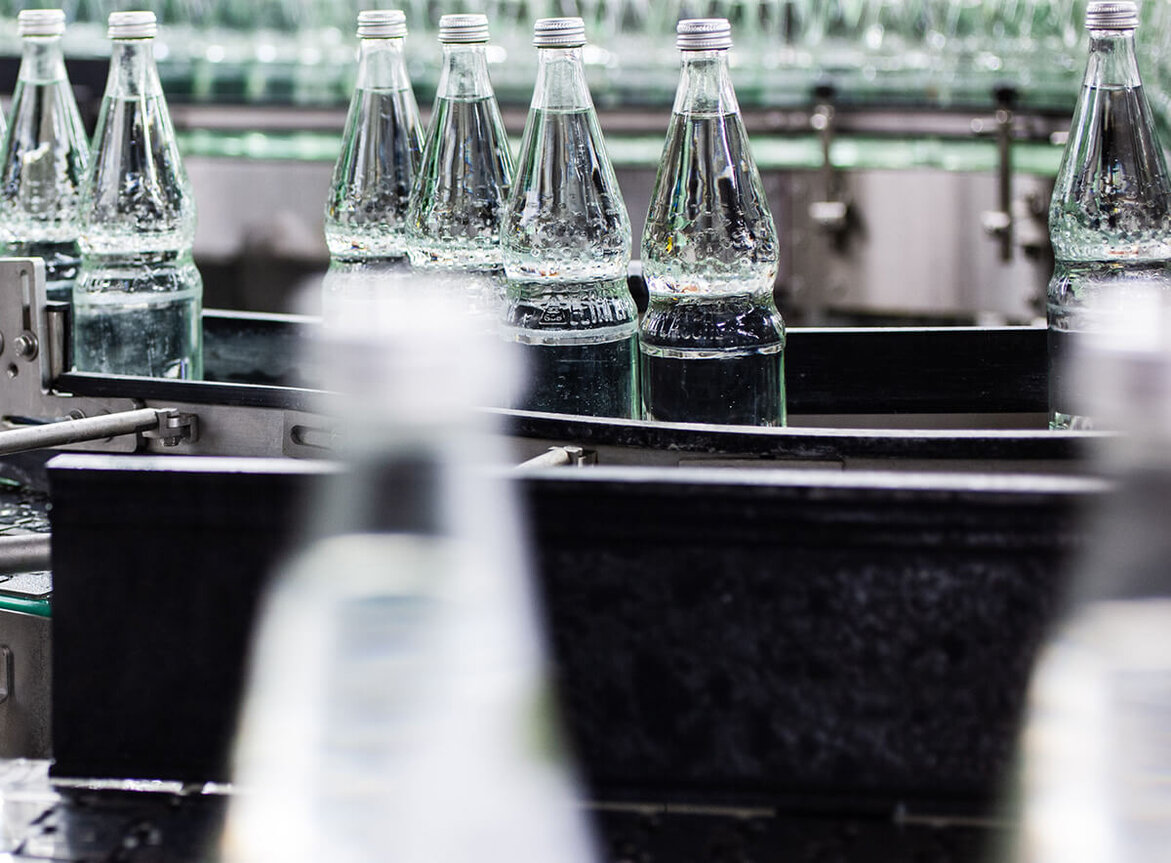 Water bottles on a conveyor belt for bottling.