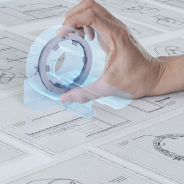 Hand holding a small round clock or stopwatch over newspaper pages.