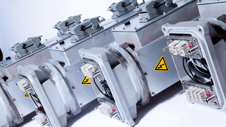 Several wind turbine slip rings on a white background.